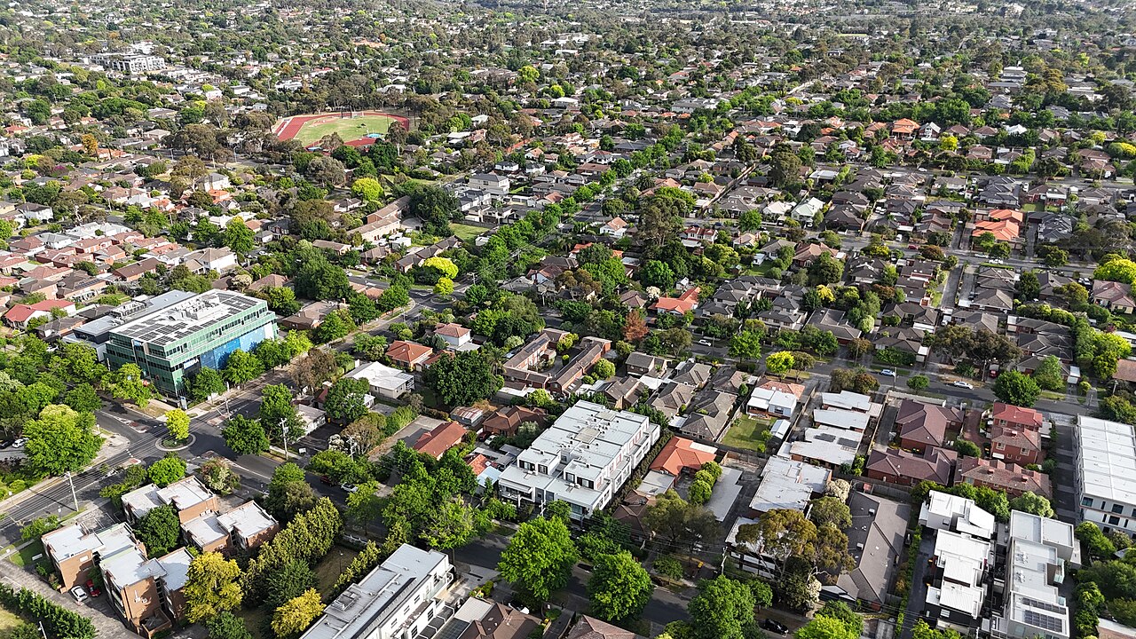 Aerial view of suburban houses and tree-lined streets