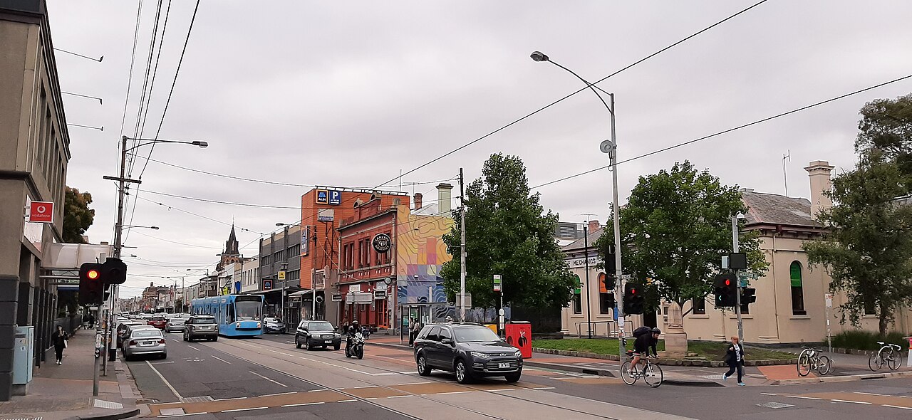 Busy street scene in Brunswick with shops and trams