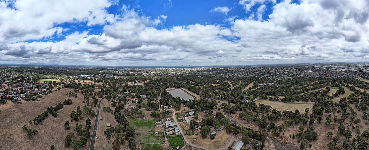 Aerial panorama of Bundoora parkland under clouds