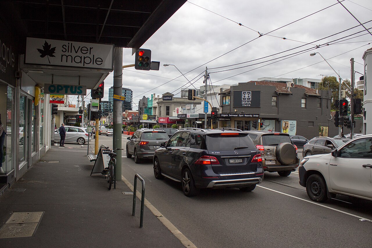 Burke Road at the Prospect Hill Road intersection, lined with shops