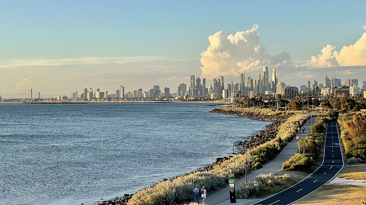 Melbourne city skyline seen across the bay from a foreshore path
