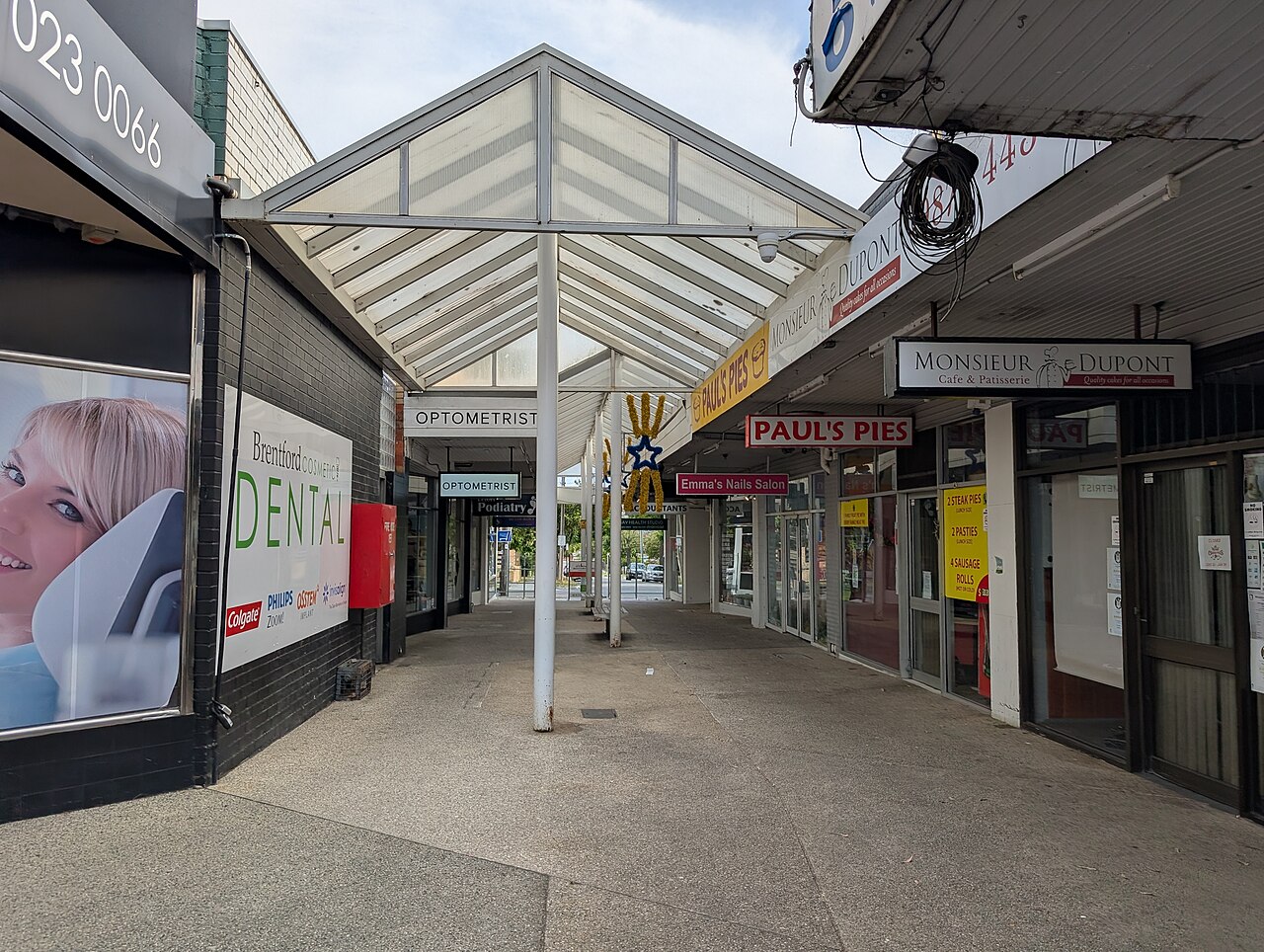 Covered walkway past shopfronts