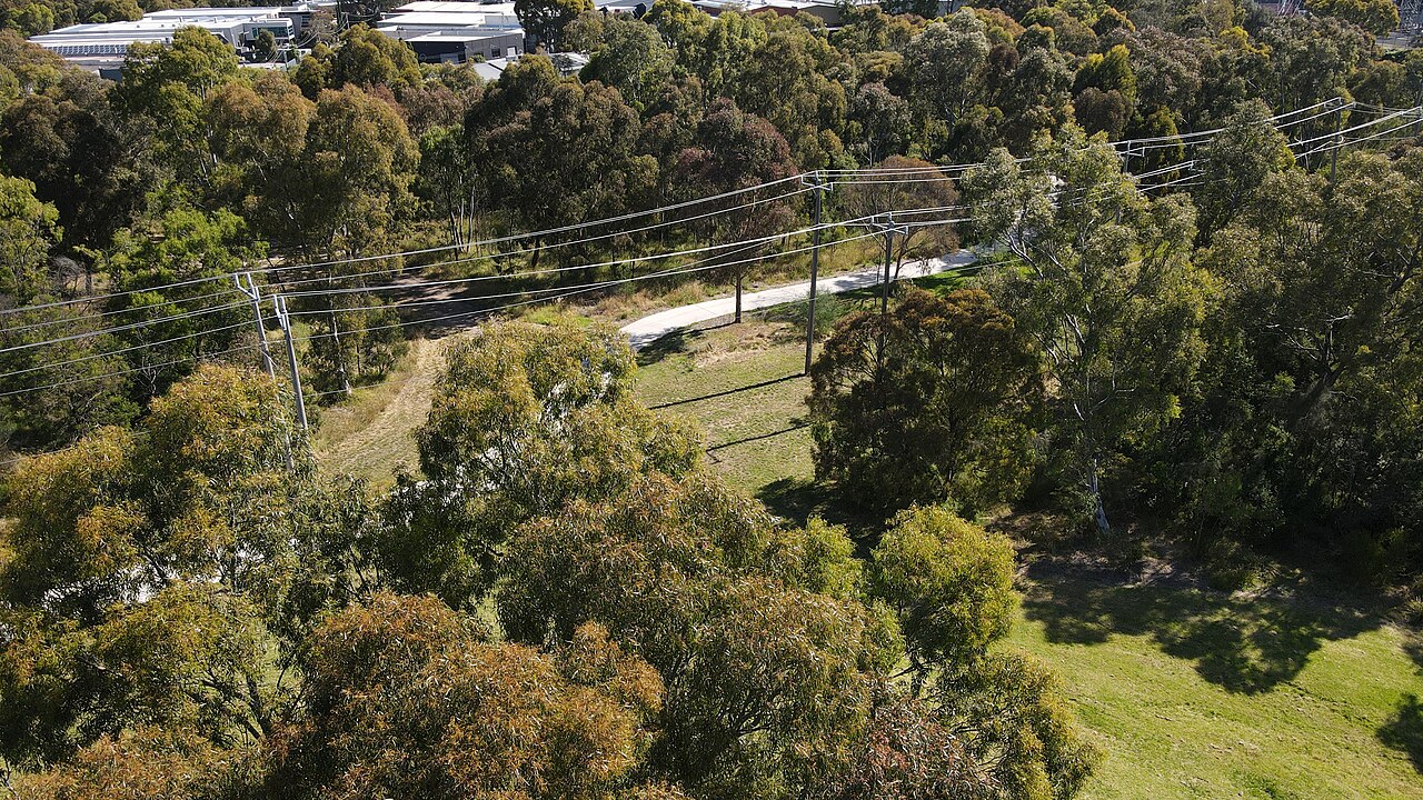 Aerial view of the Darebin Creek Trail and power lines through trees