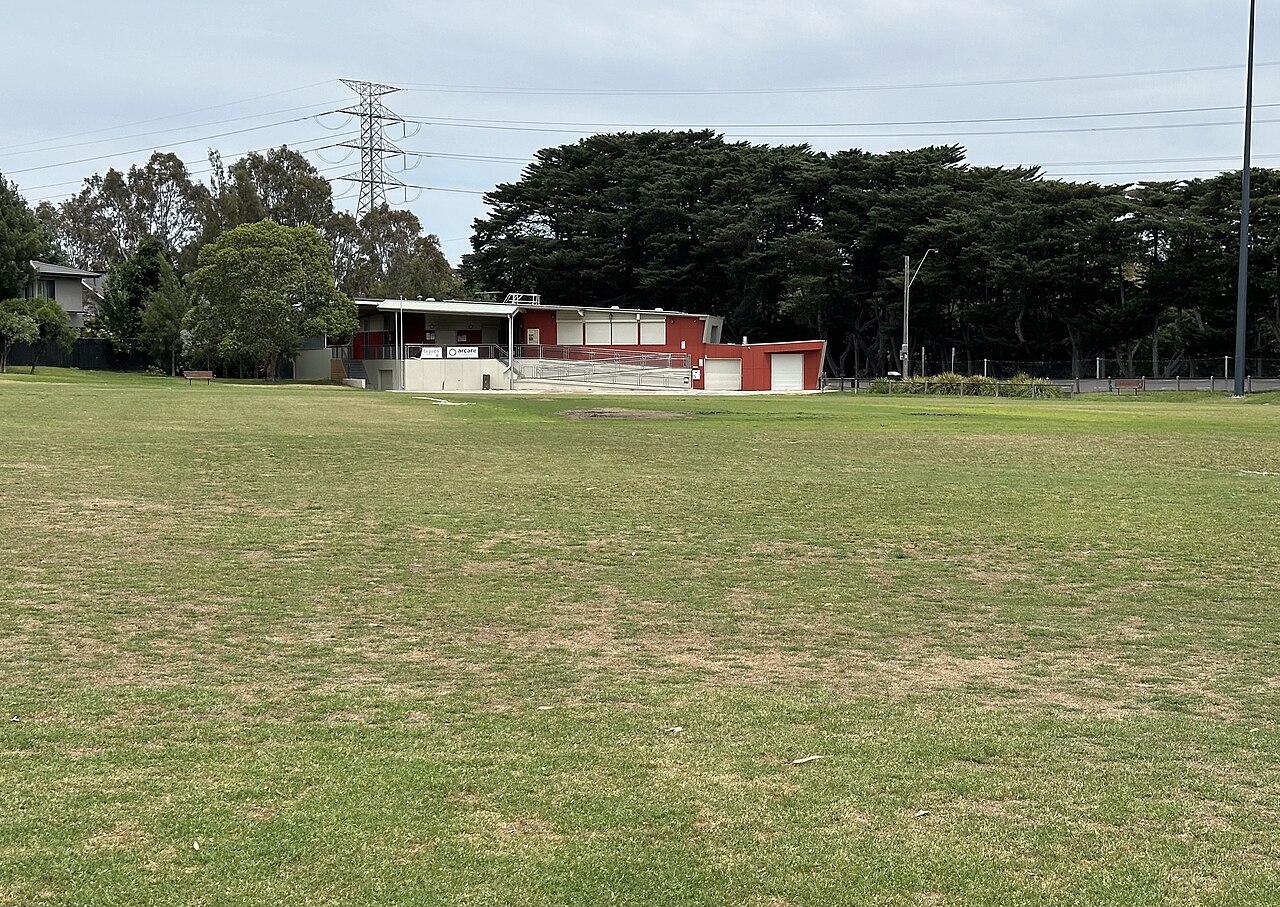 Open grass field and pavilion at Eric Raven Reserve