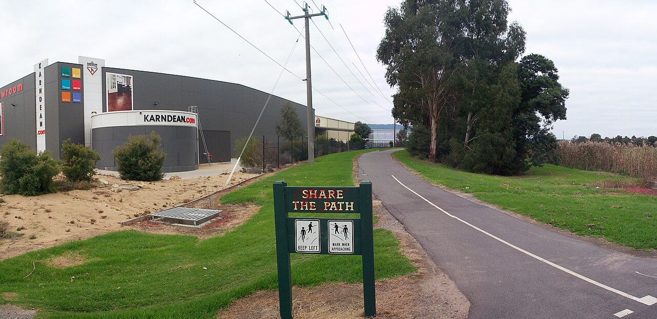 Shared path on the Ferny Creek trail beside a warehouse and gum trees