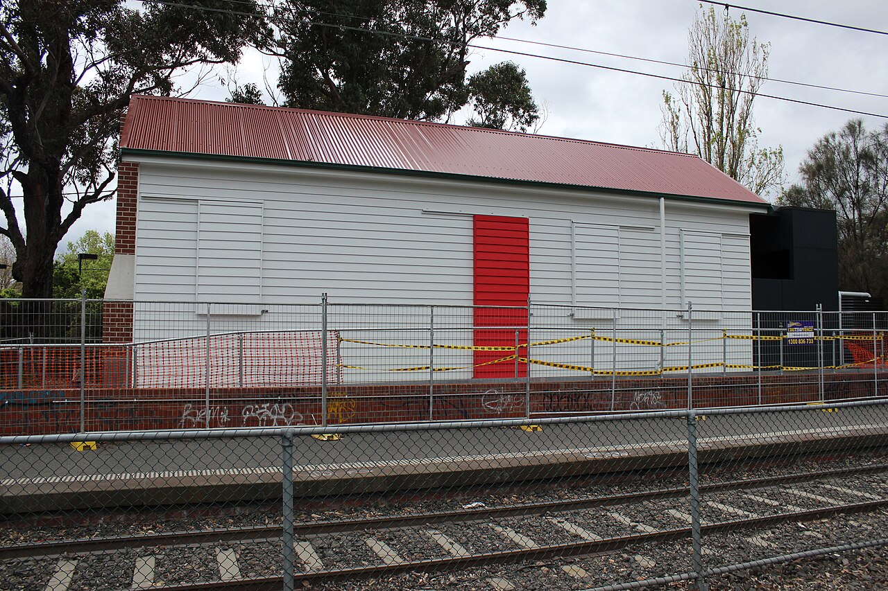 Freshly painted heritage weatherboard building beside the tram line