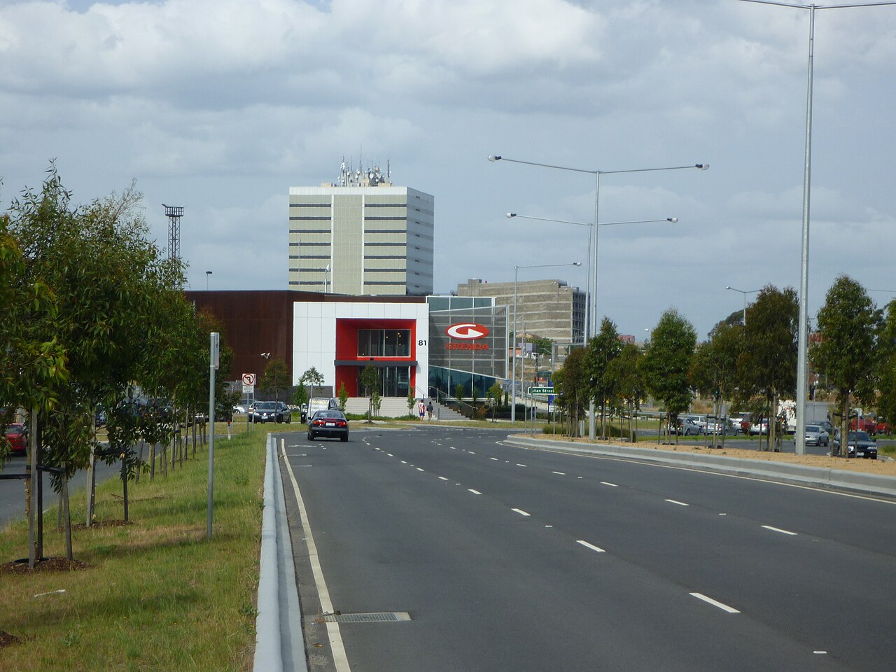 Wide road with trees and buildings in Dandenong