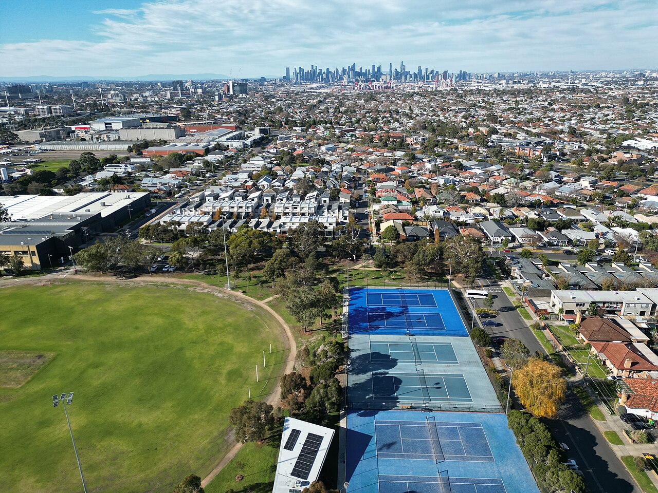 Hansen Reserve oval and courts, facing east toward the city