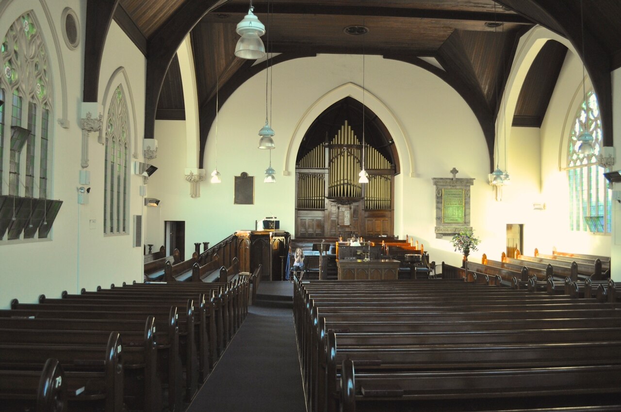 Interior of Malvern Presbyterian Church with pews and arched windows