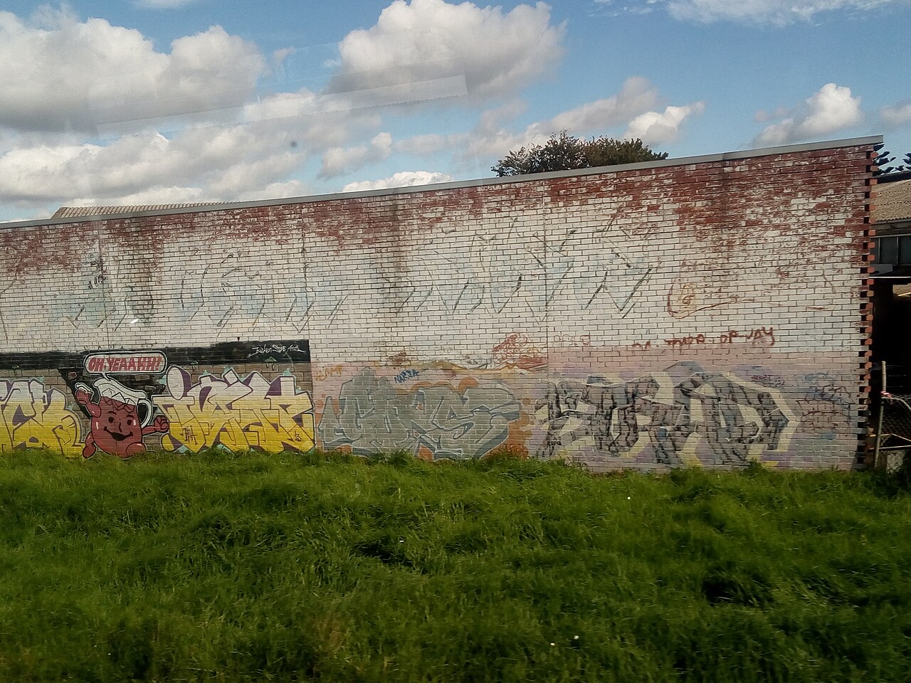 Kool-Aid Man graffiti on a brick wall in Clayton