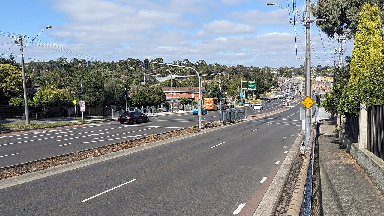 Looking east along a wide main road towards a temporary bus stop