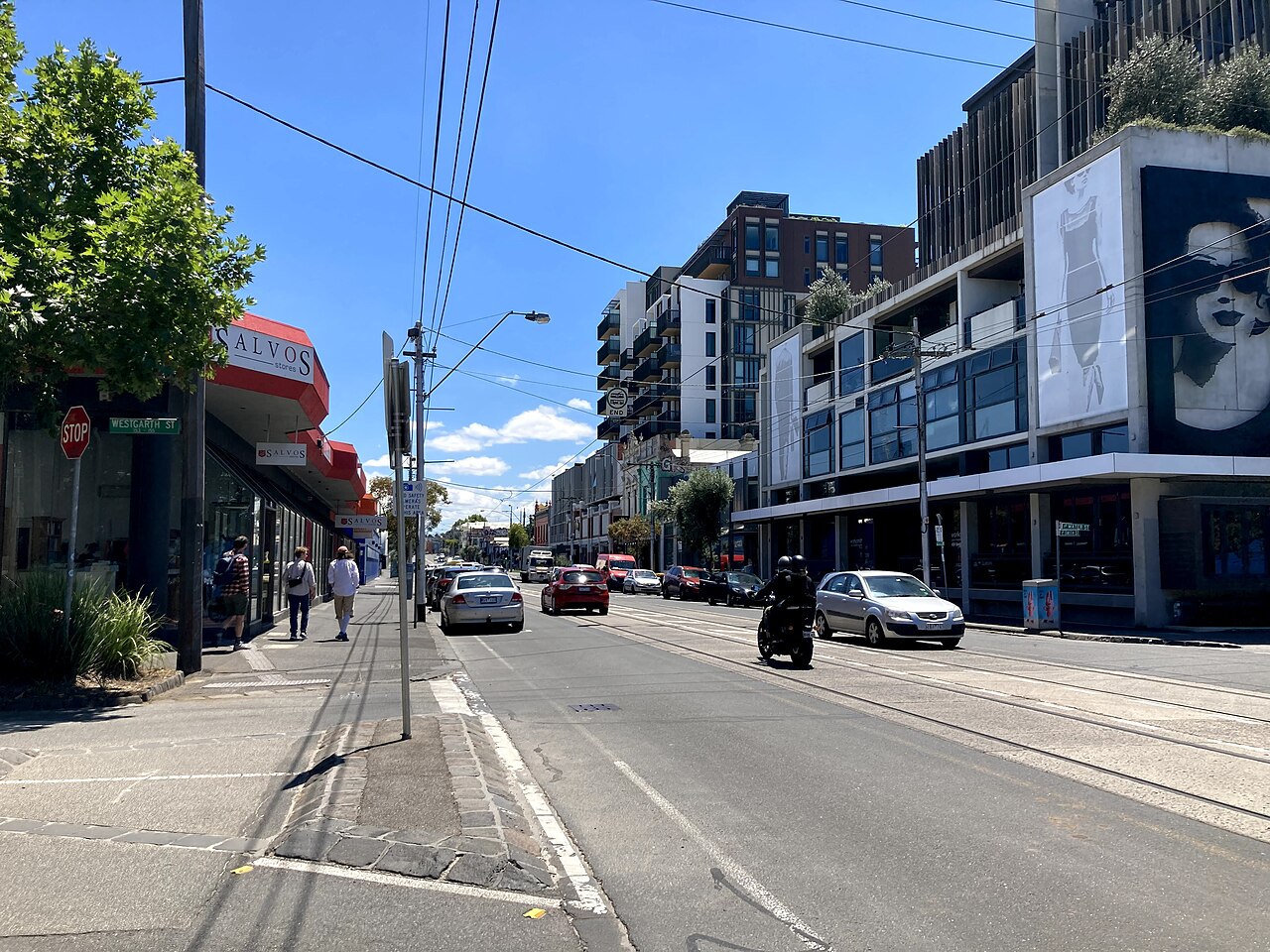 Looking north along Smith Street with tram tracks and shops