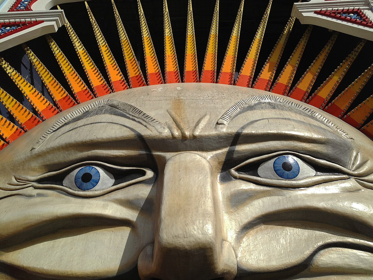Close-up of a giant sculpted face with blue eyes