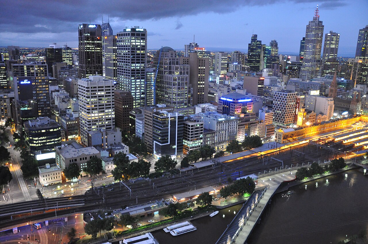 City towers and the river lit up at dusk