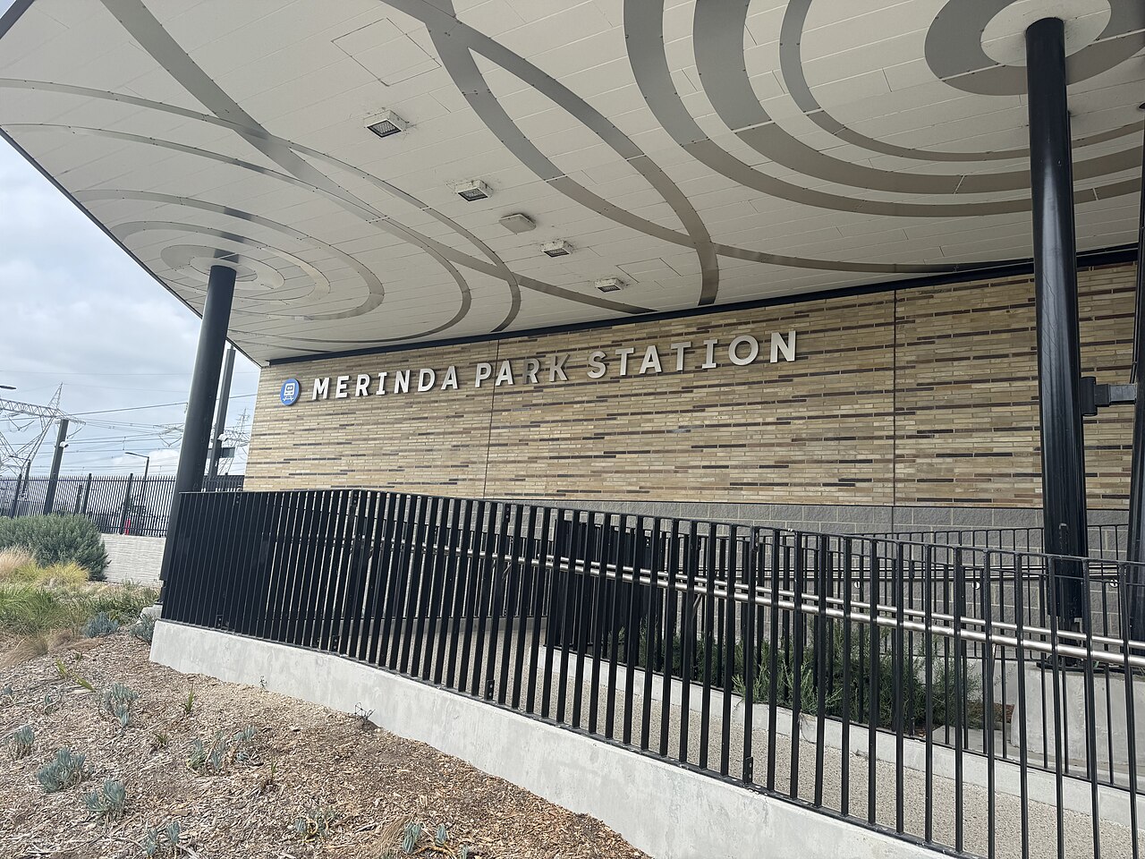 Entrance to Merinda Park railway station with its name on the wall