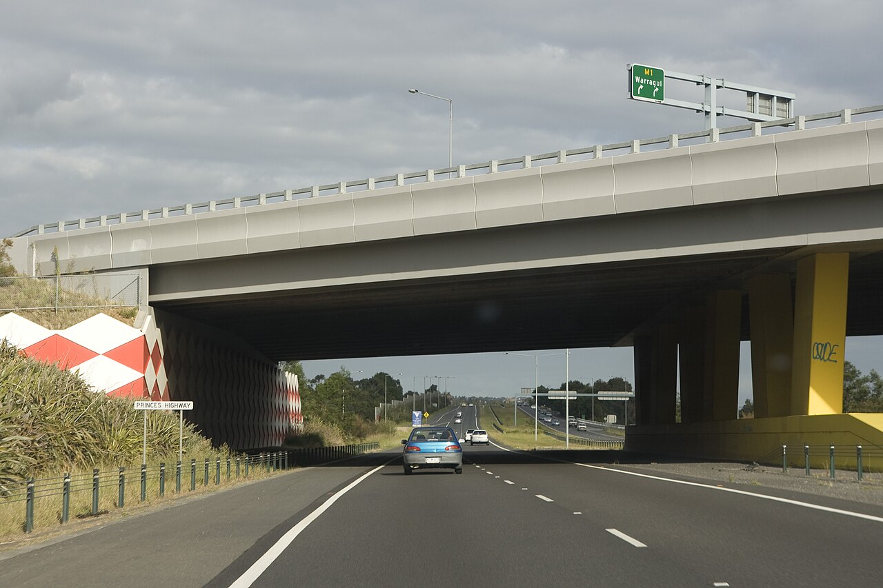 Divided road passing under a freeway overpass near Narre Warren