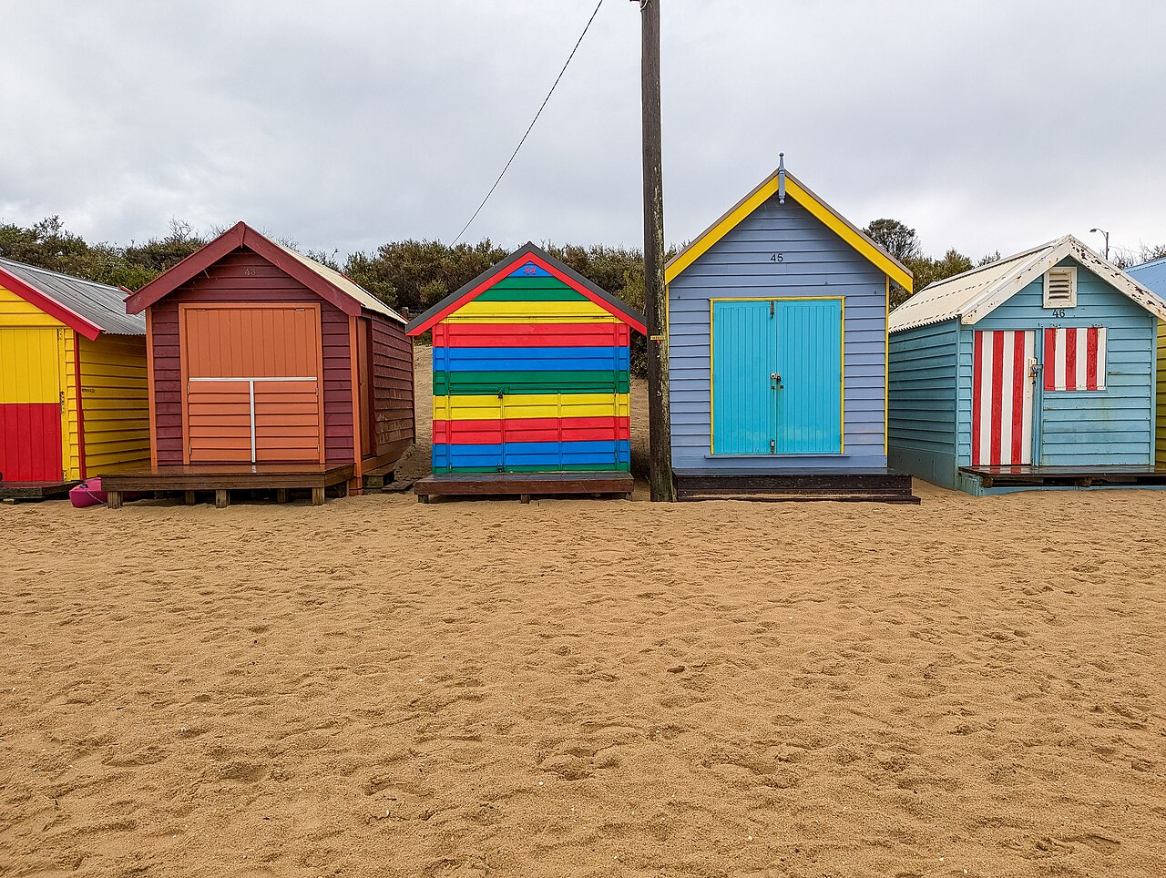 Row of colourful bathing boxes at Brighton beach