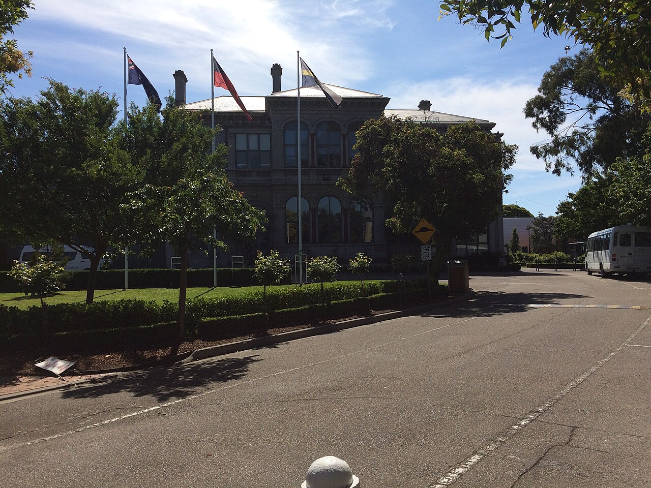 Front of St Catherine's School with gardens and flags