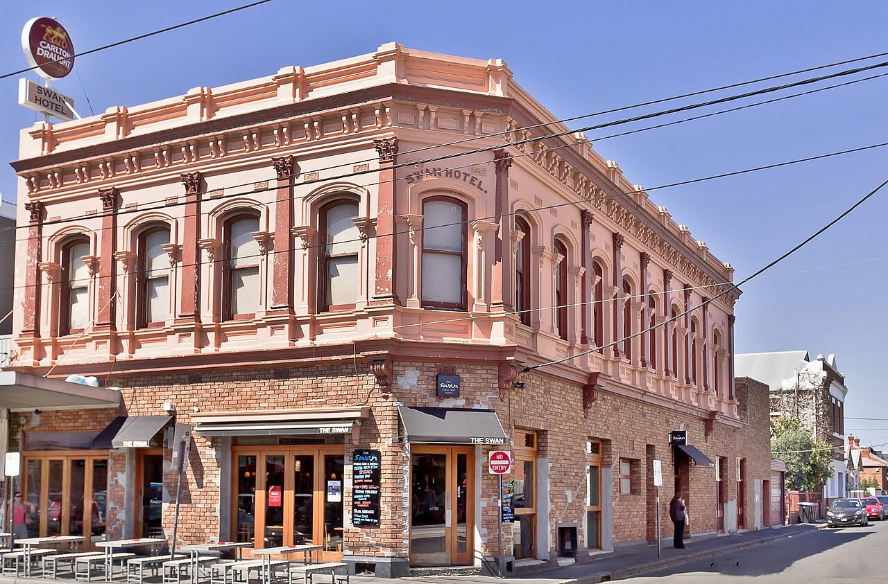 Ornate Victorian facade of the Swan Hotel on a street corner