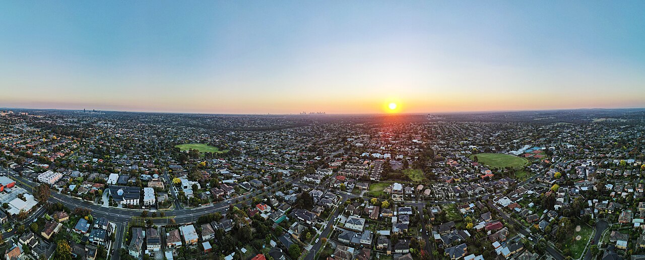 Aerial view over Templestowe Lower rooftops at sunset