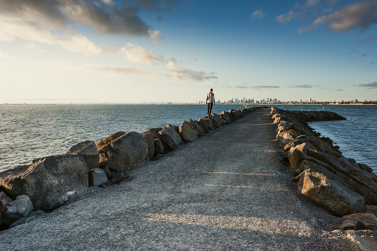 Rock breakwater stretching into the bay
