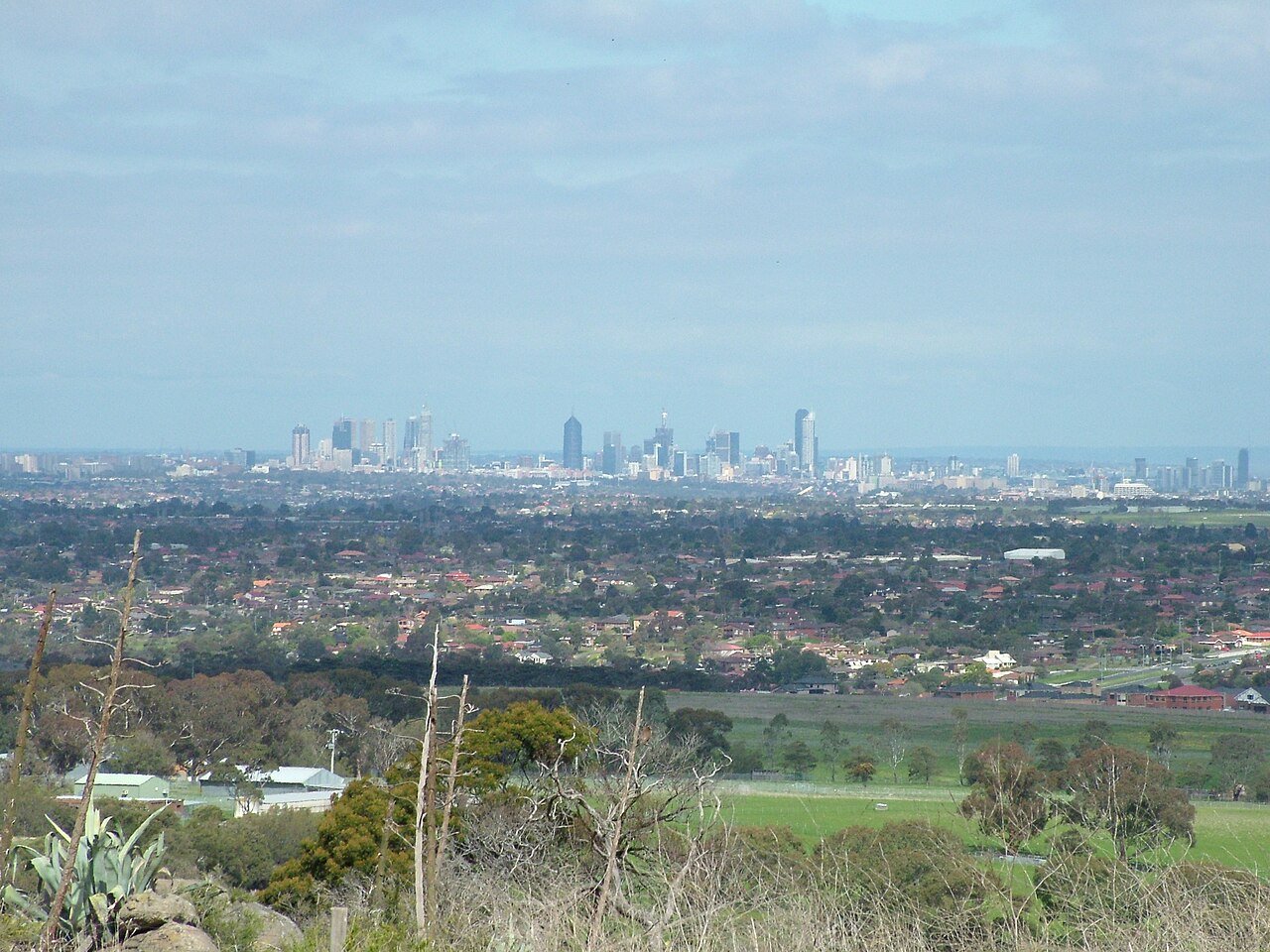 Distant view over Tullamarine Airport to the Melbourne skyline