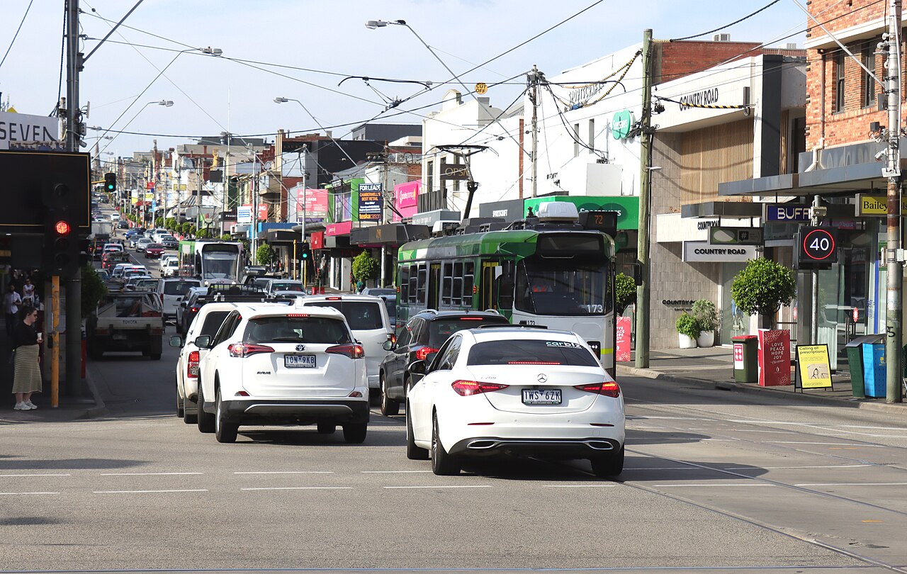 Trams and traffic heading south along Burke Road at Camberwell Junction