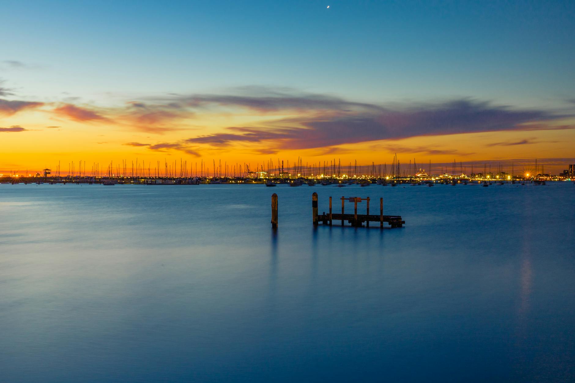 Morning walkers along St Kilda Pier with bay views