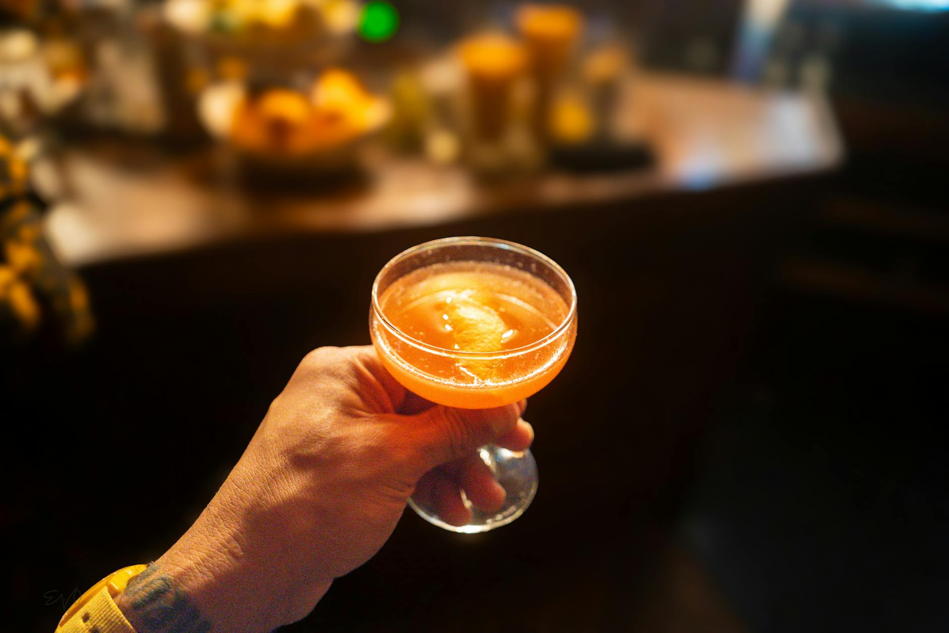 Evening scene on Toorak Road with warmly lit bar frontages and outdoor seating